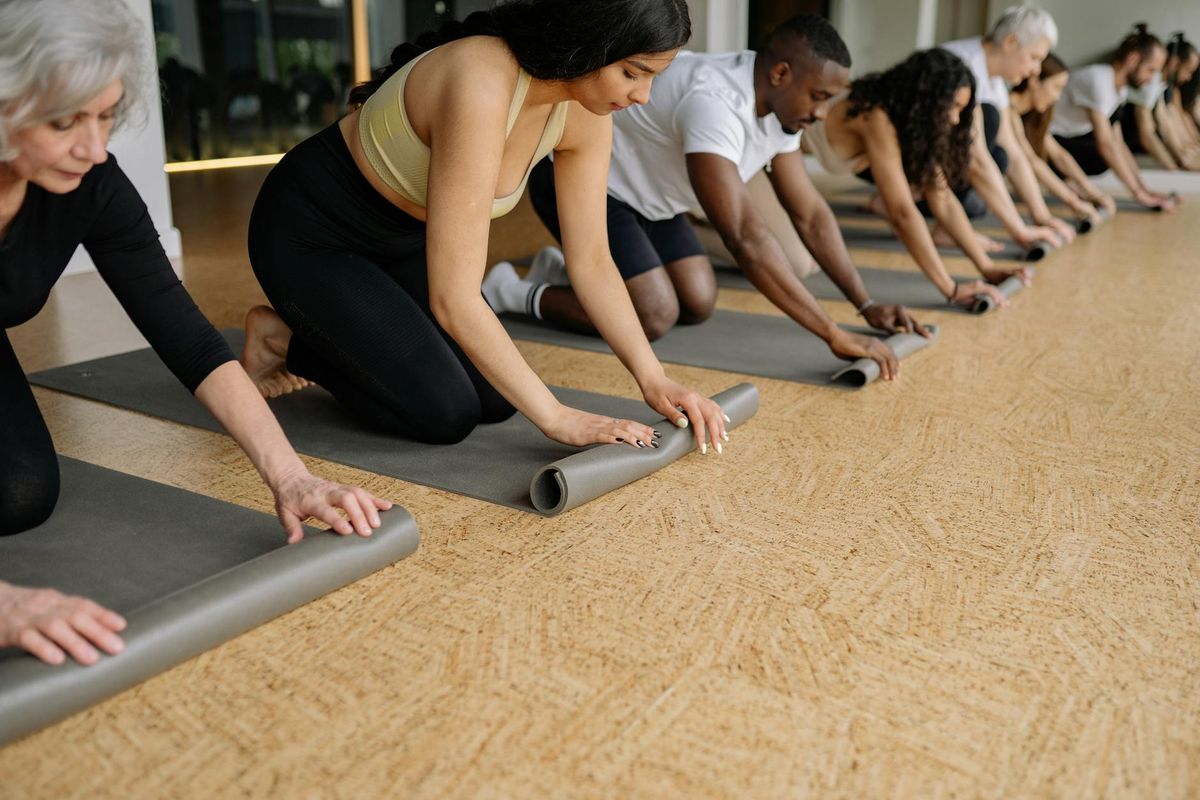 Close up of yoga mat and wooden floor background.