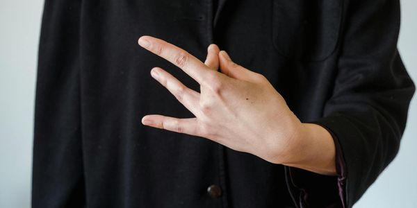 Detail of hands in a meditative mudra position.